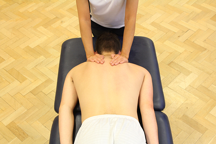 Swedish massage treatment on upper shoulders in Manchester clinic