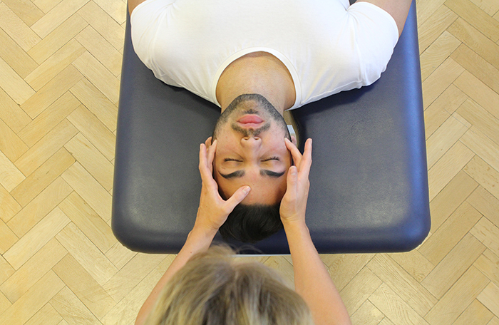 Therapeutic massage treatment on head in Manchester clinic