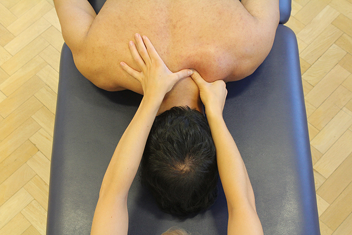 Trigger pointing massage technique in upper neck area in Manchester clinic