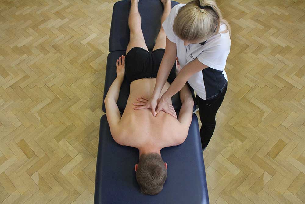 Trigger point massage into erector spinae muscle