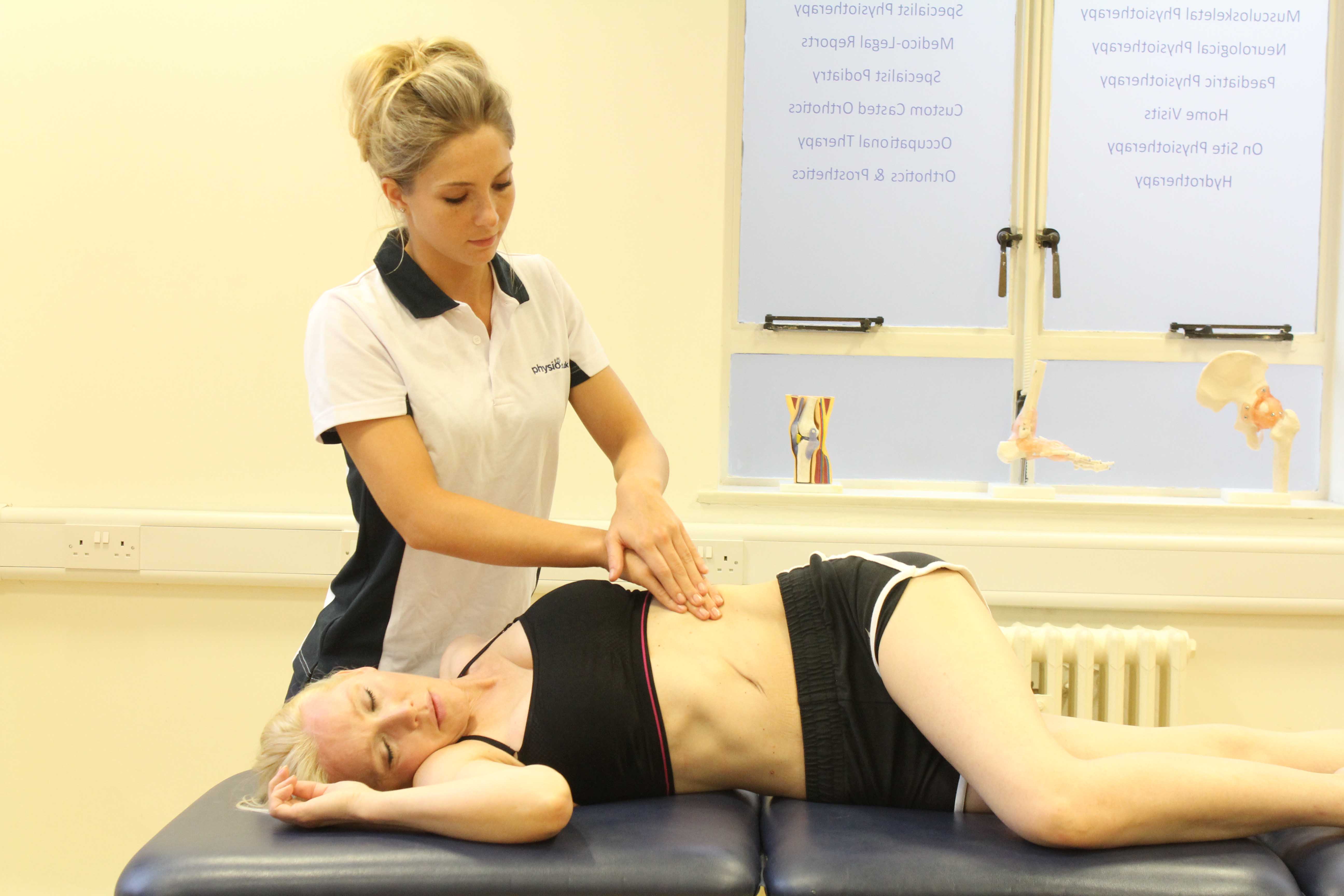 Soft tissue massage and stretch of the abdominal muscles by an experienced therapist