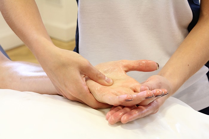 Acupressure massage technique on hand in Manchester clinic