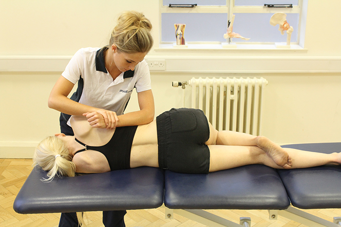 Massage customer receiving shoulder massage in manchester clinic