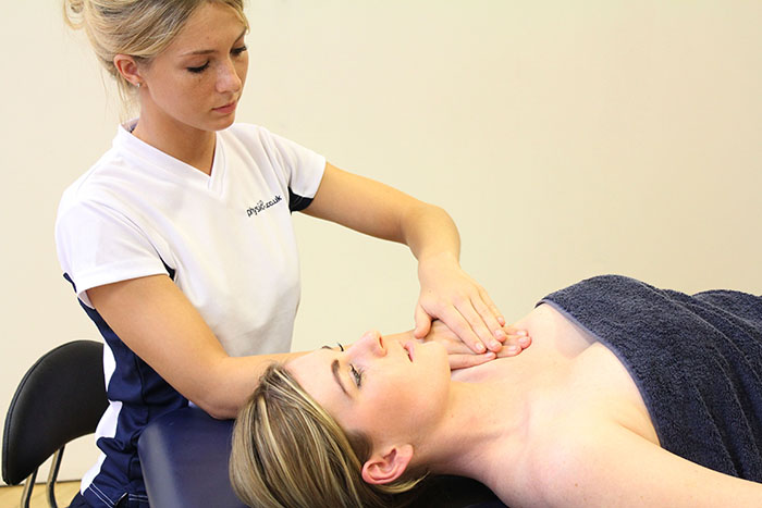 Remedial massage treatment on upper shoulder in Manchester Clinic