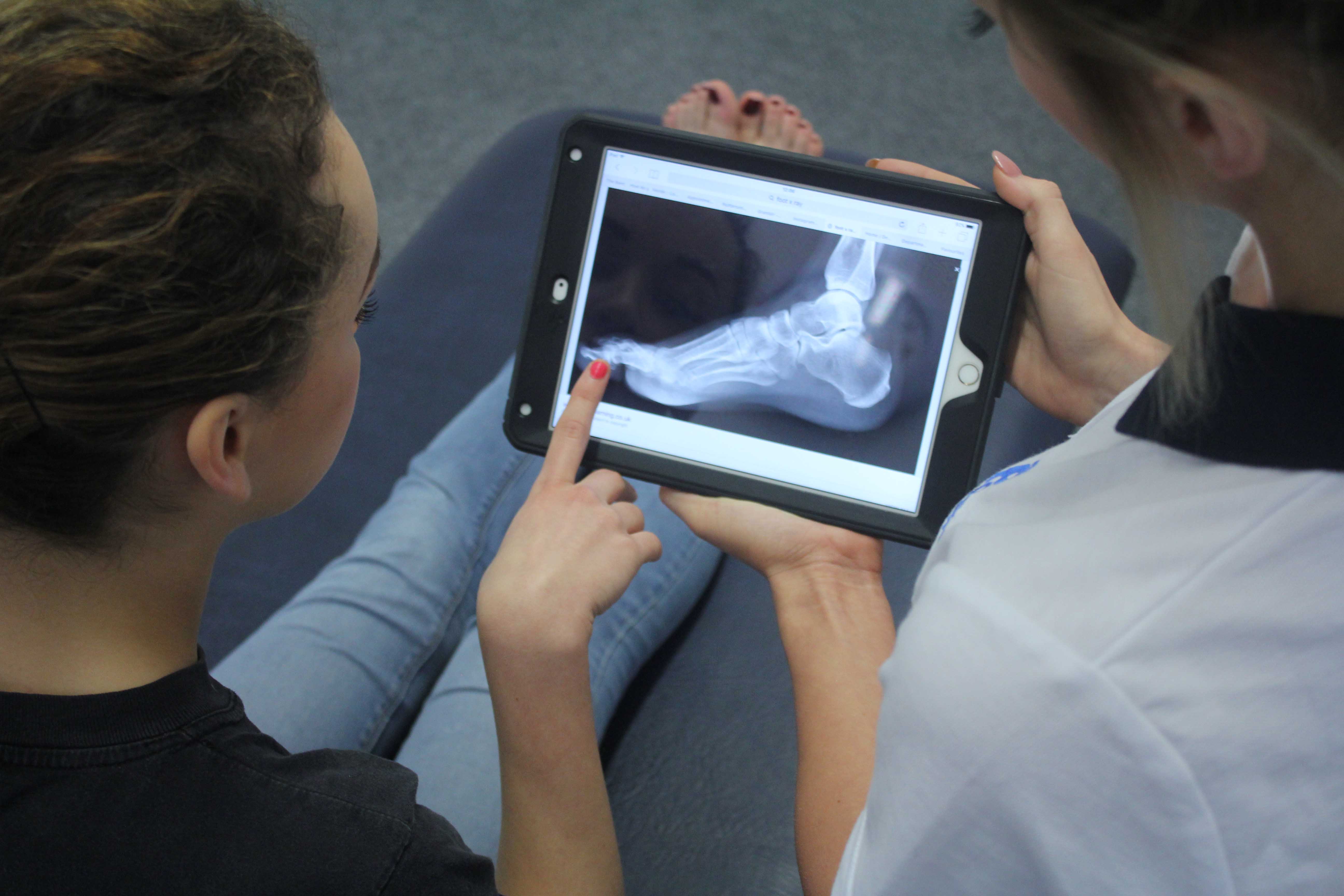 Our physiotherapist educating her patient on her ankle injury.