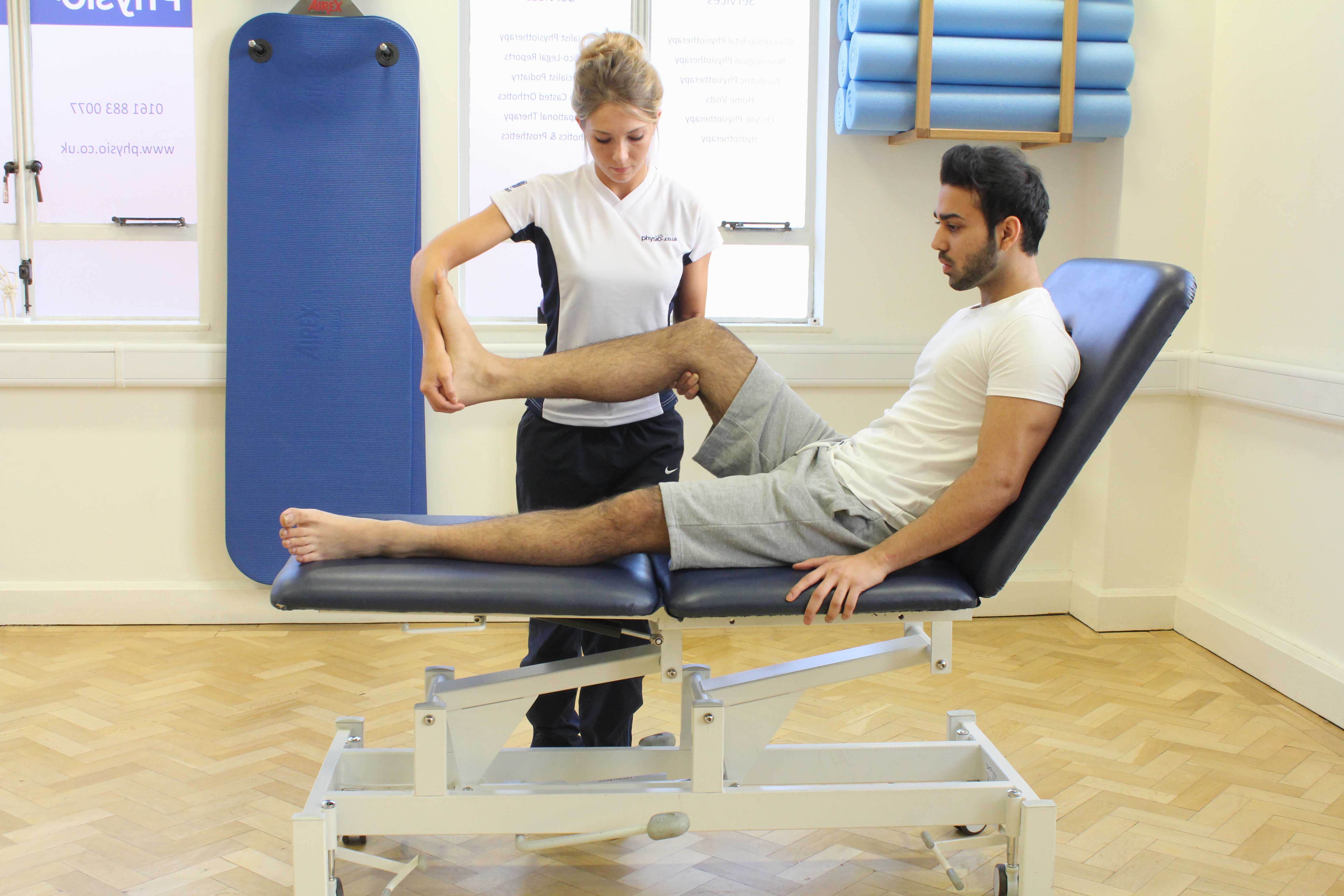 Therapist performing knee assessment Therapist performing knee assessment