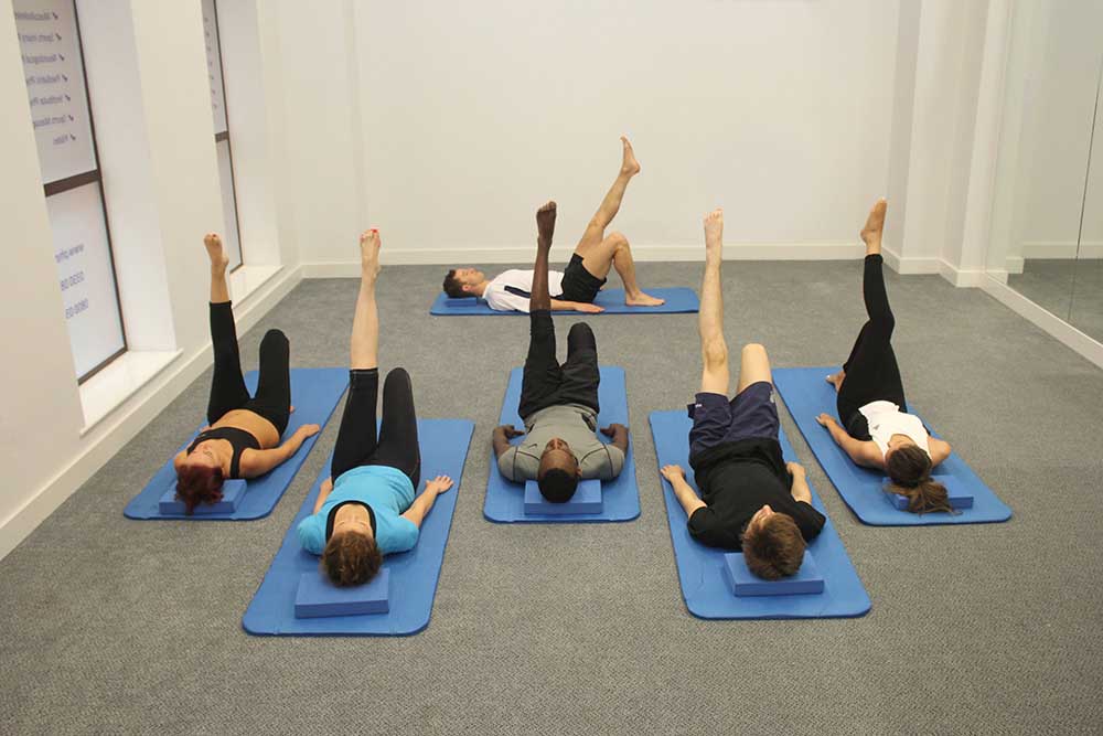 Beginners pilates class working on gentle core strengthening. Beginners pilates class working on gentle core strengthening.