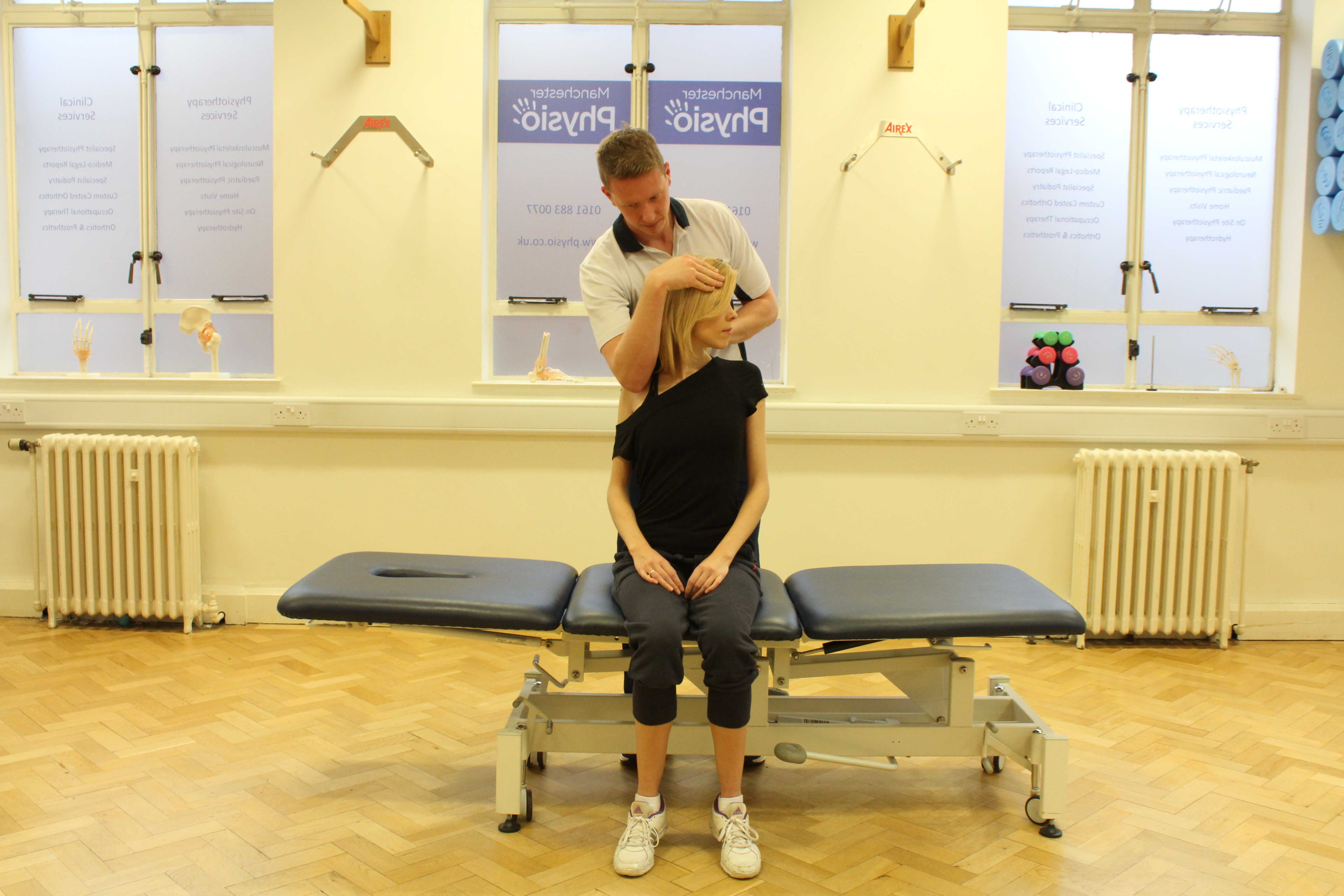 Experienced Physiotherapist conducting an assessment of the cervical spine, muscles and connective tissues in the neck