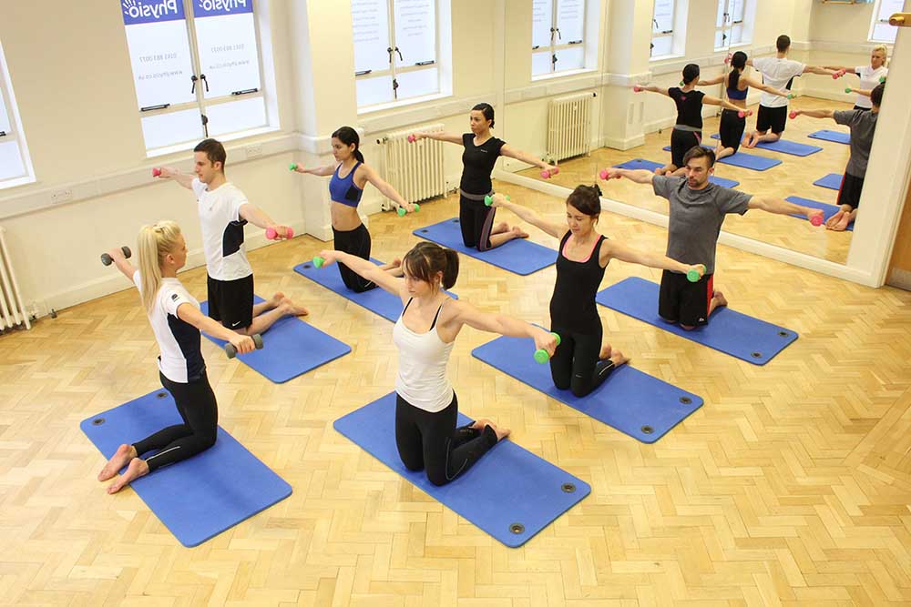 Physiotherapist led pilates class using resistance bands