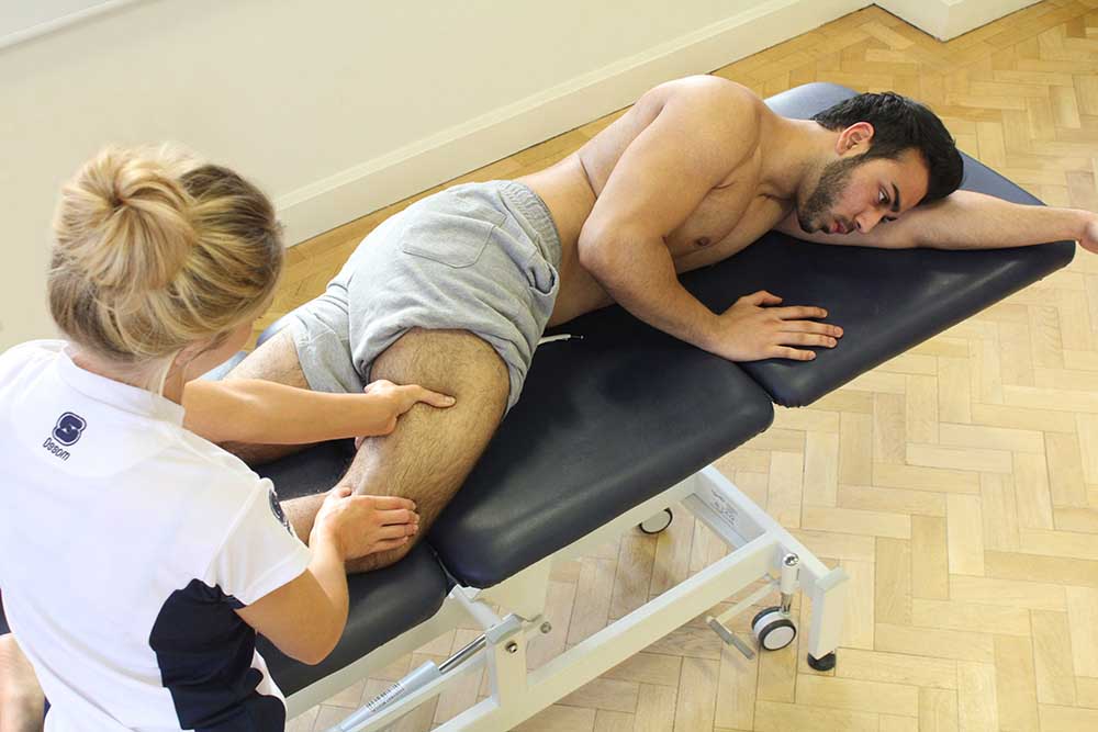Deep tissue massage on vastus lateralis muscle