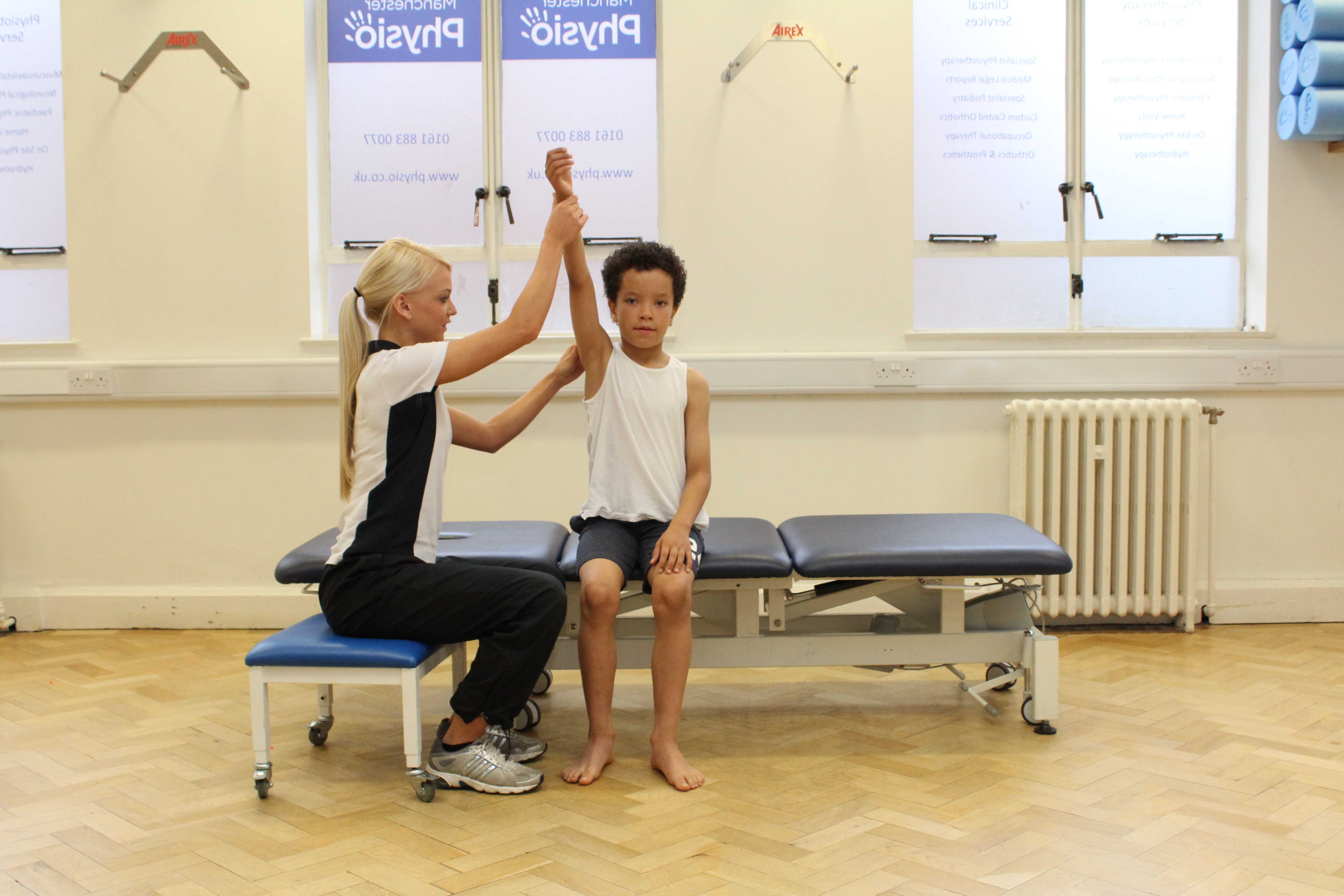 passive mobility and stretch exercises for the arm and shoulder performed by a paediatric neuro physiotherapist