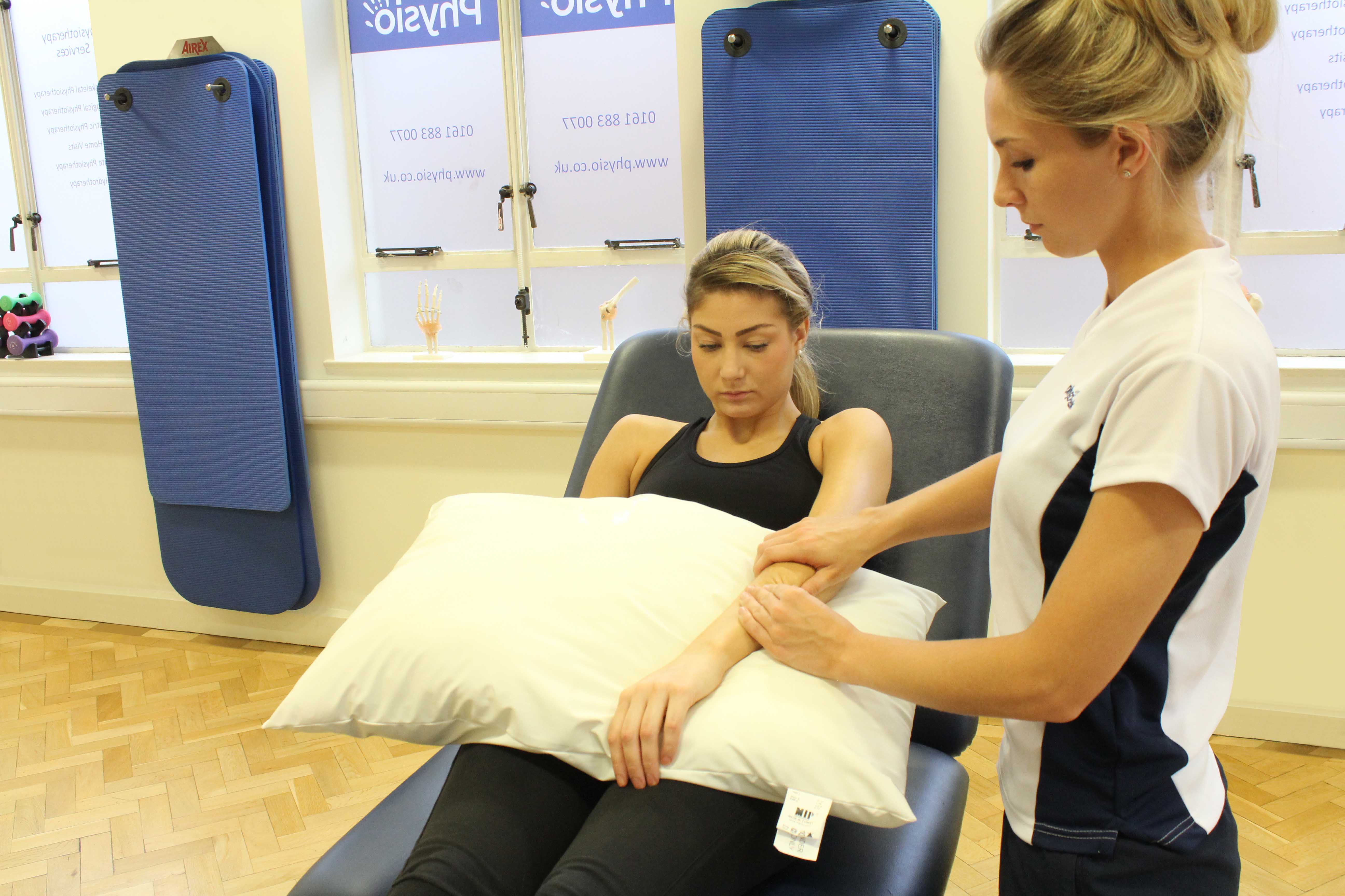 Soft tissue massage of the muscle and tendons in the forearm