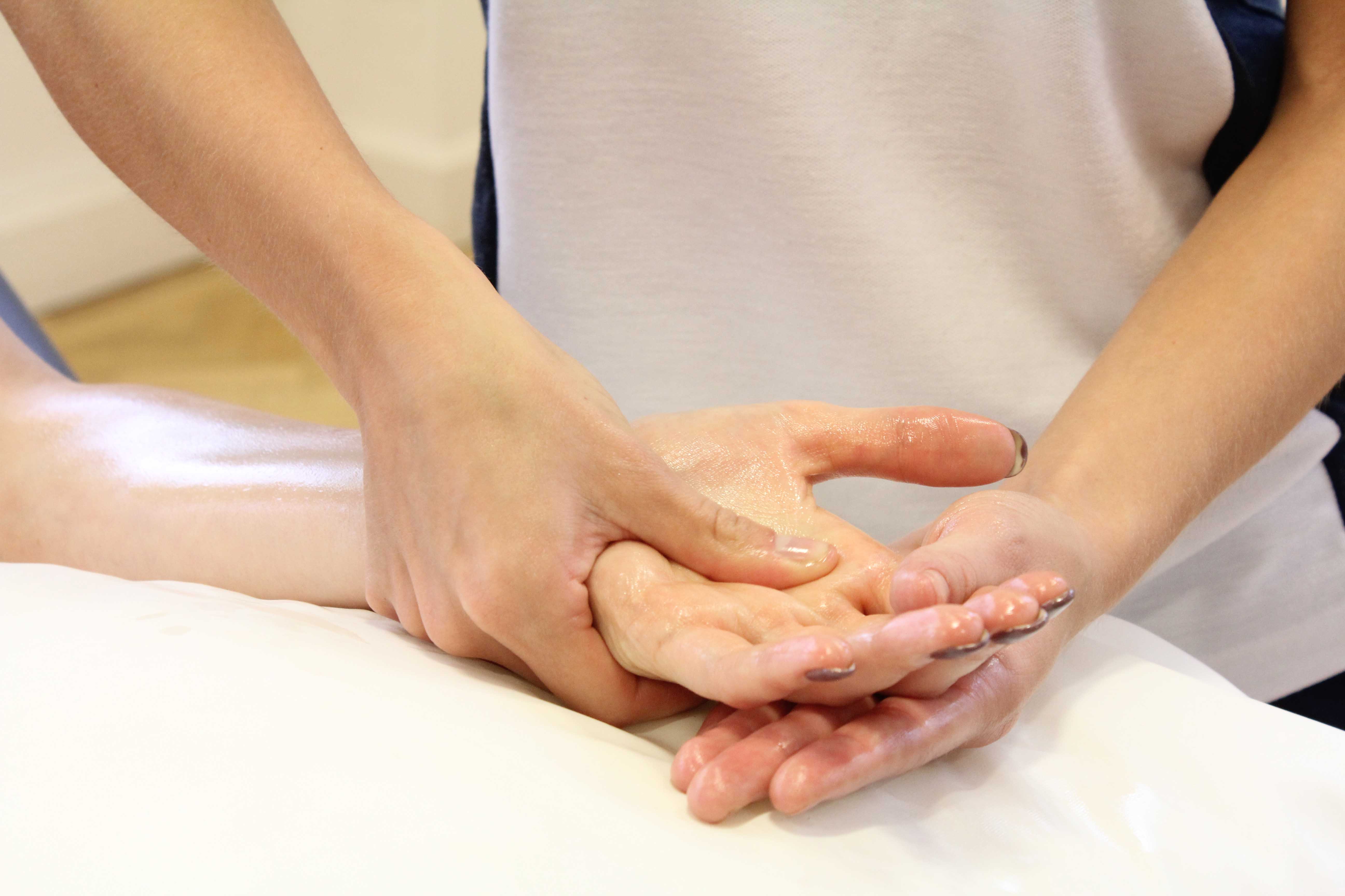 Therapist soft tissue massage of the metacarpals and connective tissues in the hand