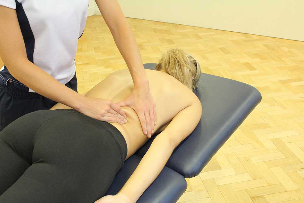 Soft Tissue Massage targeting lower latissimus dorsi and erector spinae