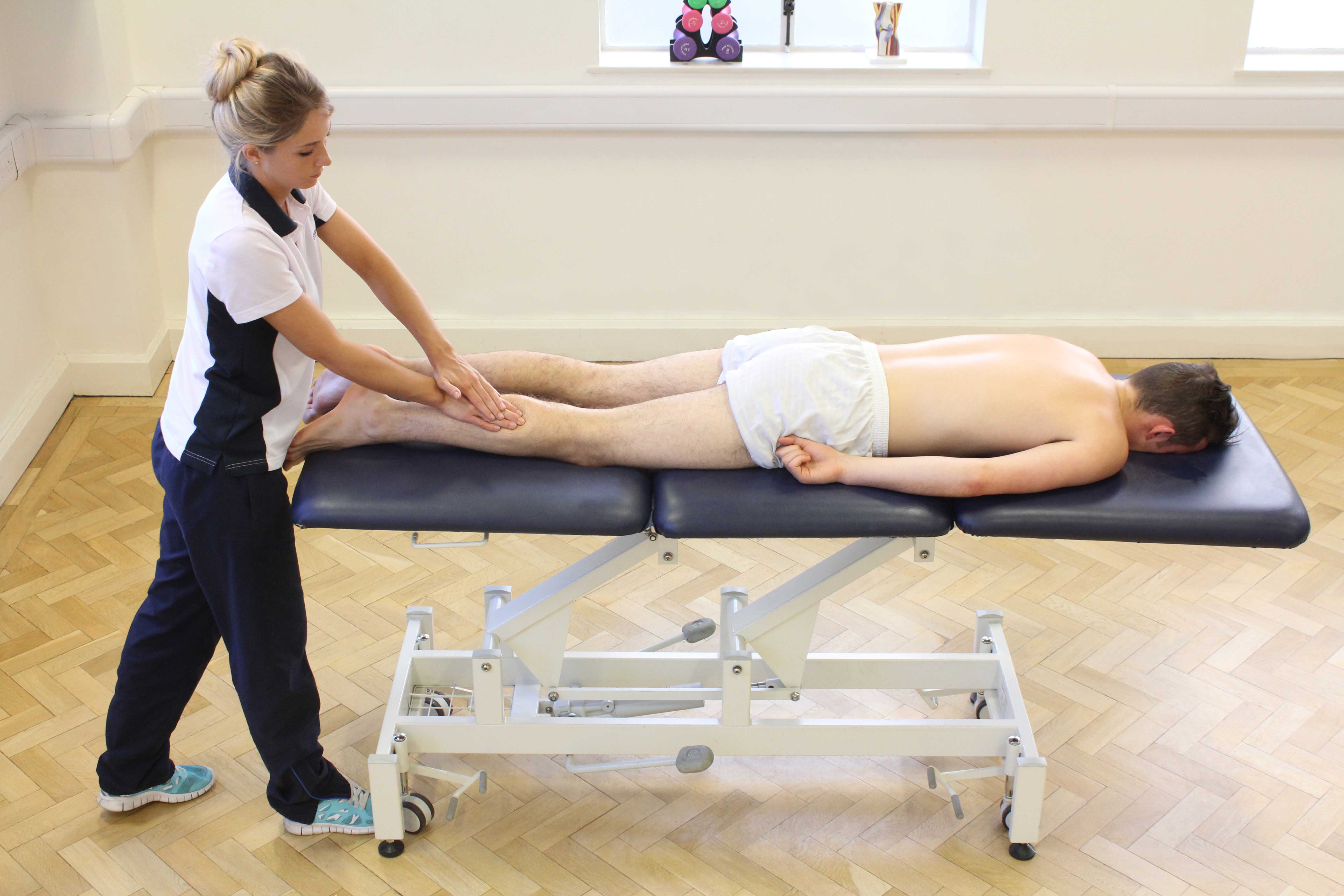 Soft tissue massage of the gastrocnemius muscle by an experienced therapist Soft tissue massage of the gastrocnemius muscle by an experienced therapist