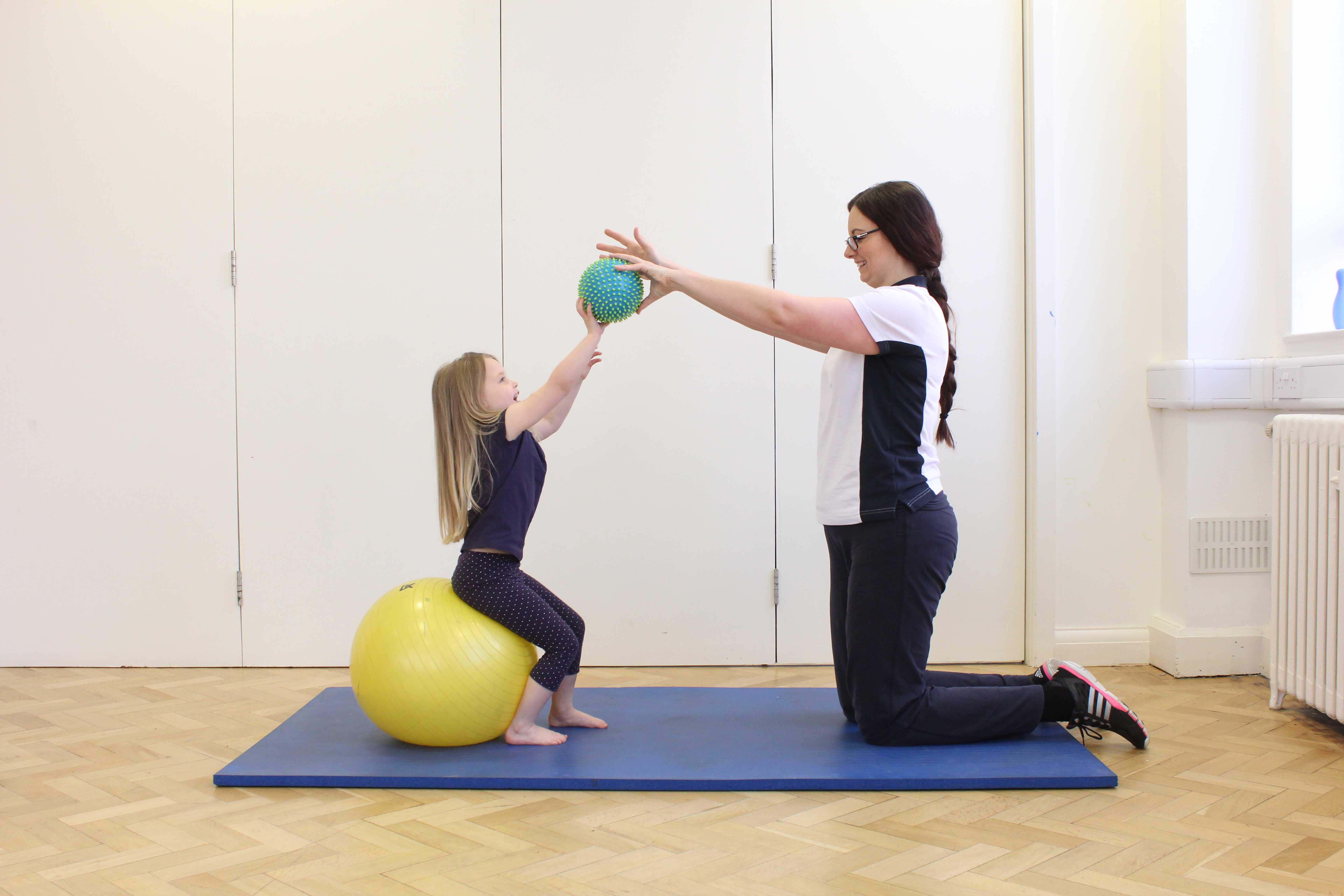 Core stability and strengthening exercises assisted by a paediatric physiotherapist