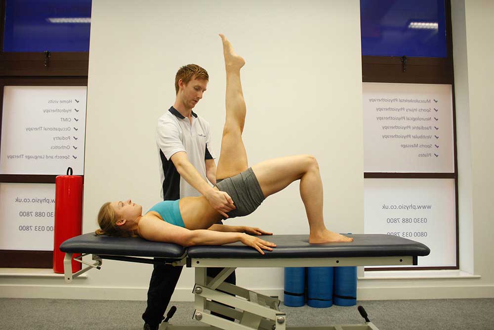 Physiotherapist led pilates class using foam rolls 