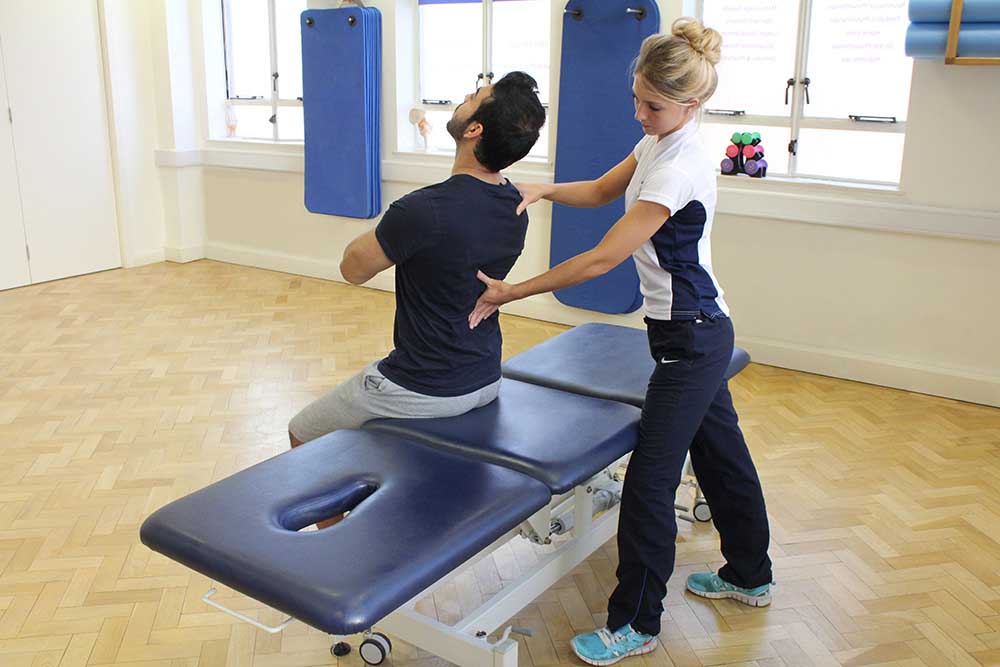 Therapist coaching client on thier postural alignment