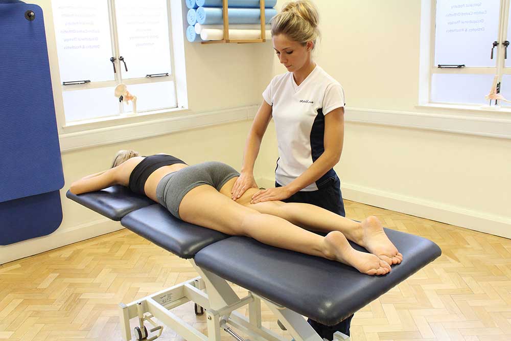 Rolling soft tissue massage of the hamstring muscles by a specilaist therapist