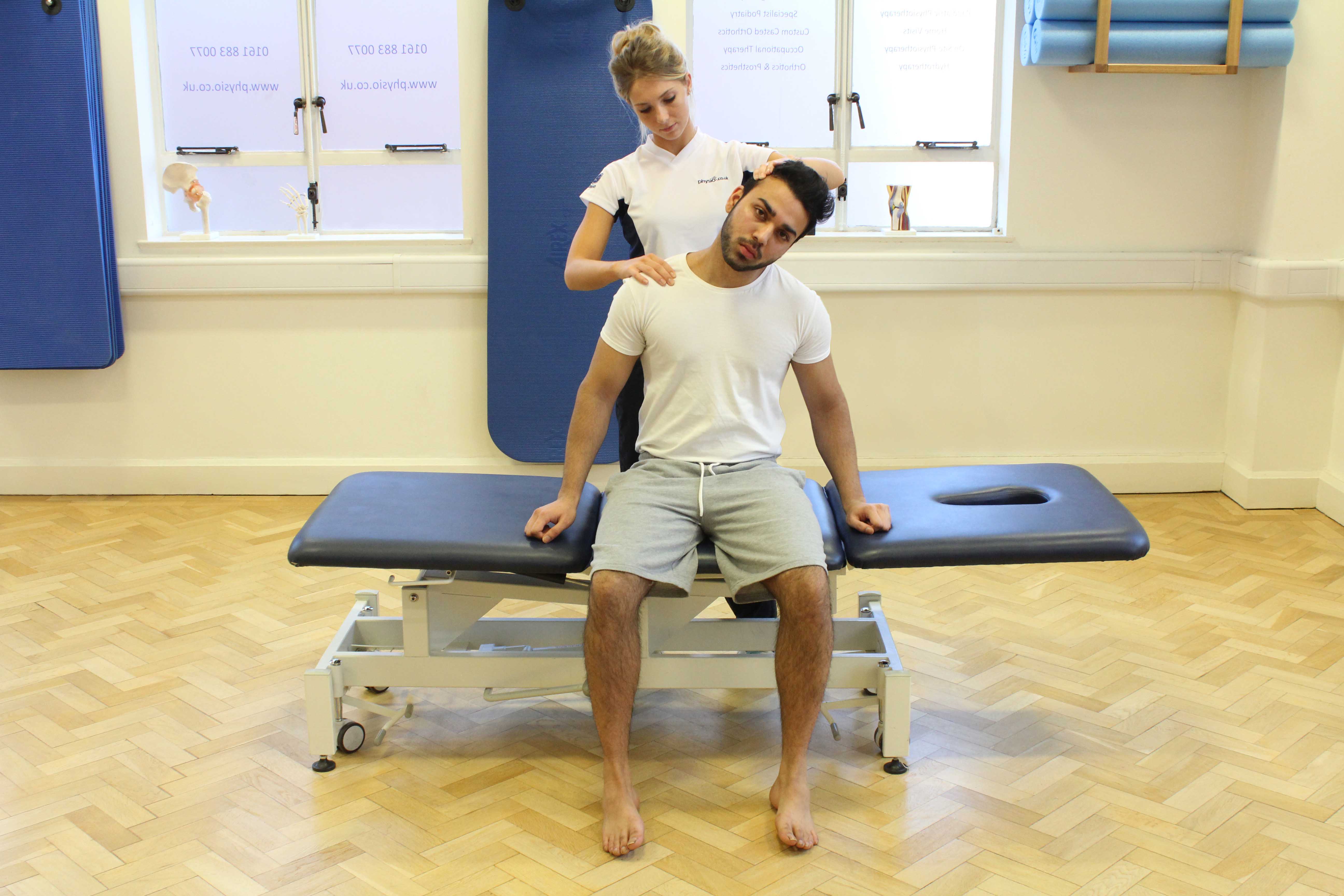 Passive stretch of the trapezius muscle in the neck by experienced therapist Passive stretch of the trapezius muscle in the neck by experienced therapist