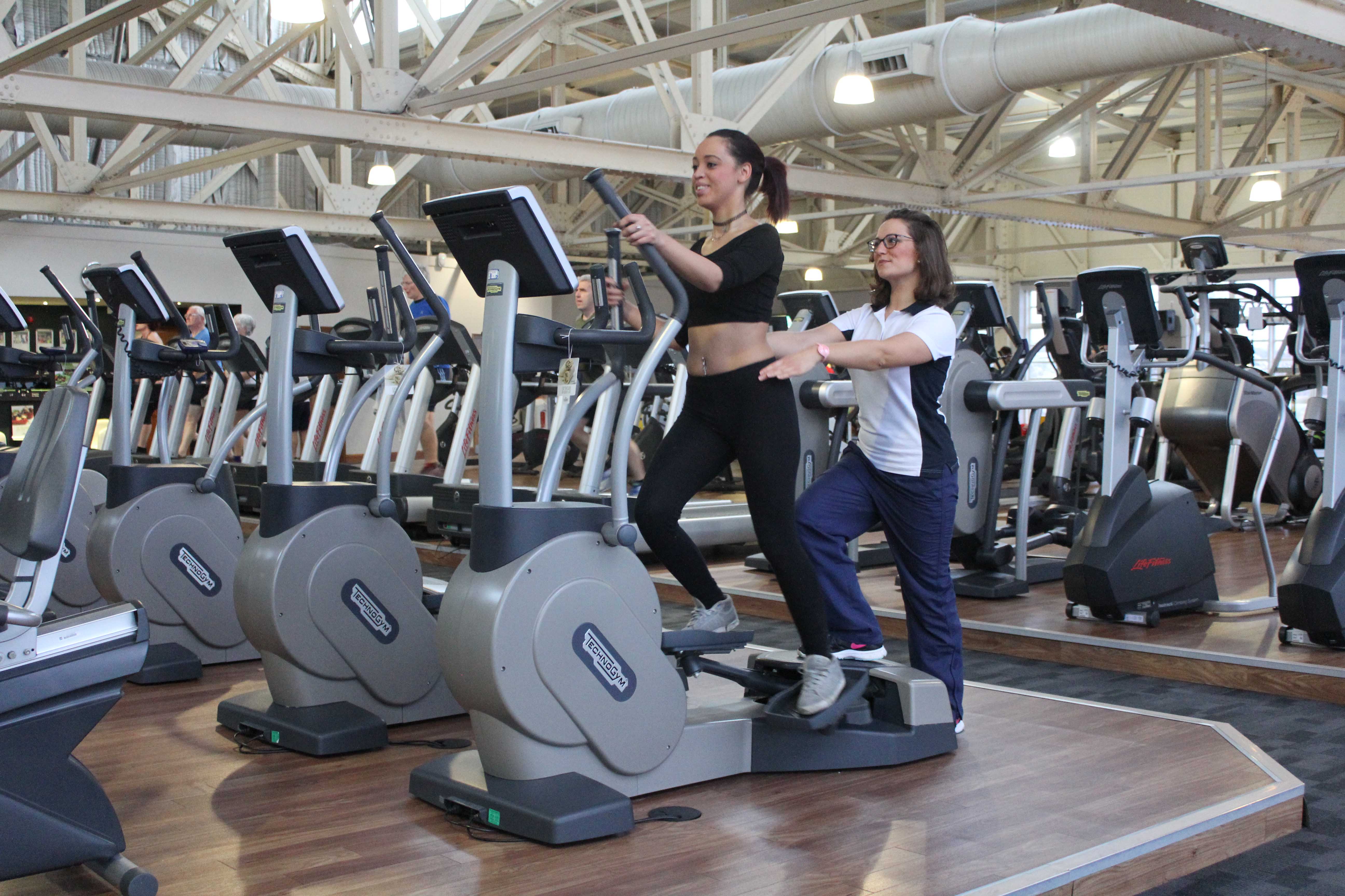 Leg strengthening exercises on a cross trainer supervised by an experienced physiotherapist Leg strengthening exercises on a cross trainer supervised by an experienced physiotherapist