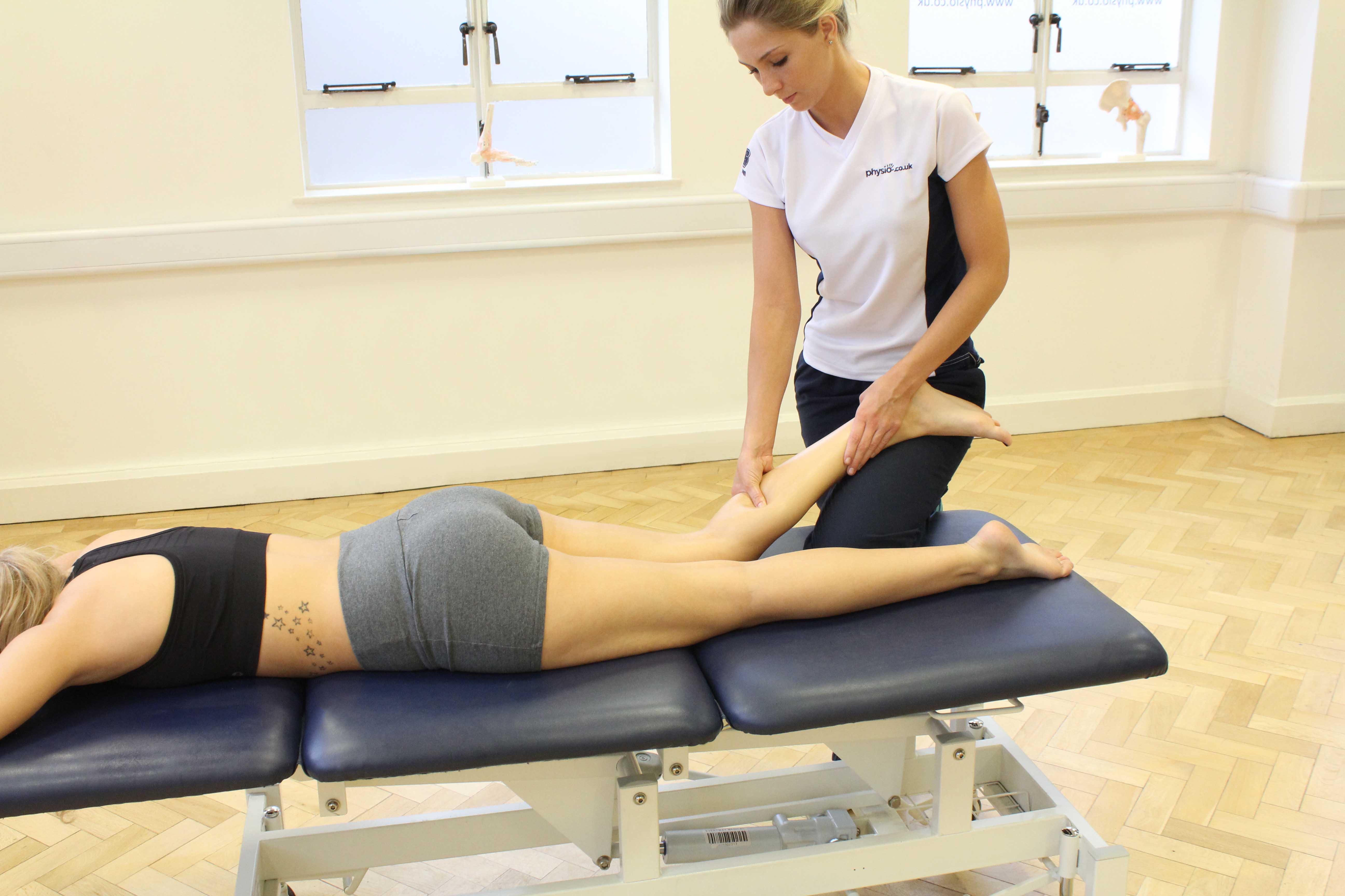 Trigger point massage applied to gastrocnemius muscle by specilaist therapist Trigger point massage applied to gastrocnemius muscle by specilaist therapist
