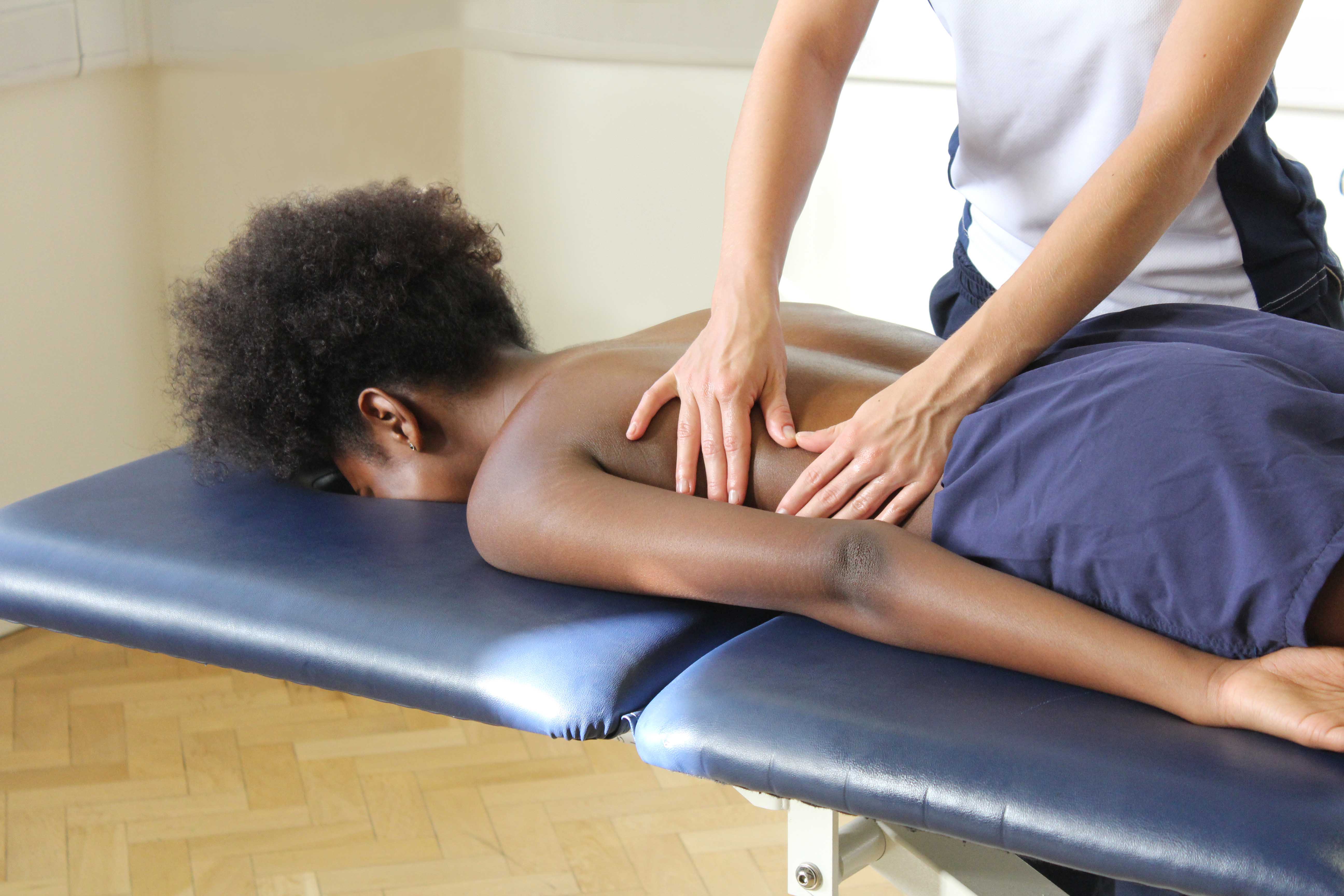 Soft tissue massage of the lower back muscles and connective tissue by specialist therapist