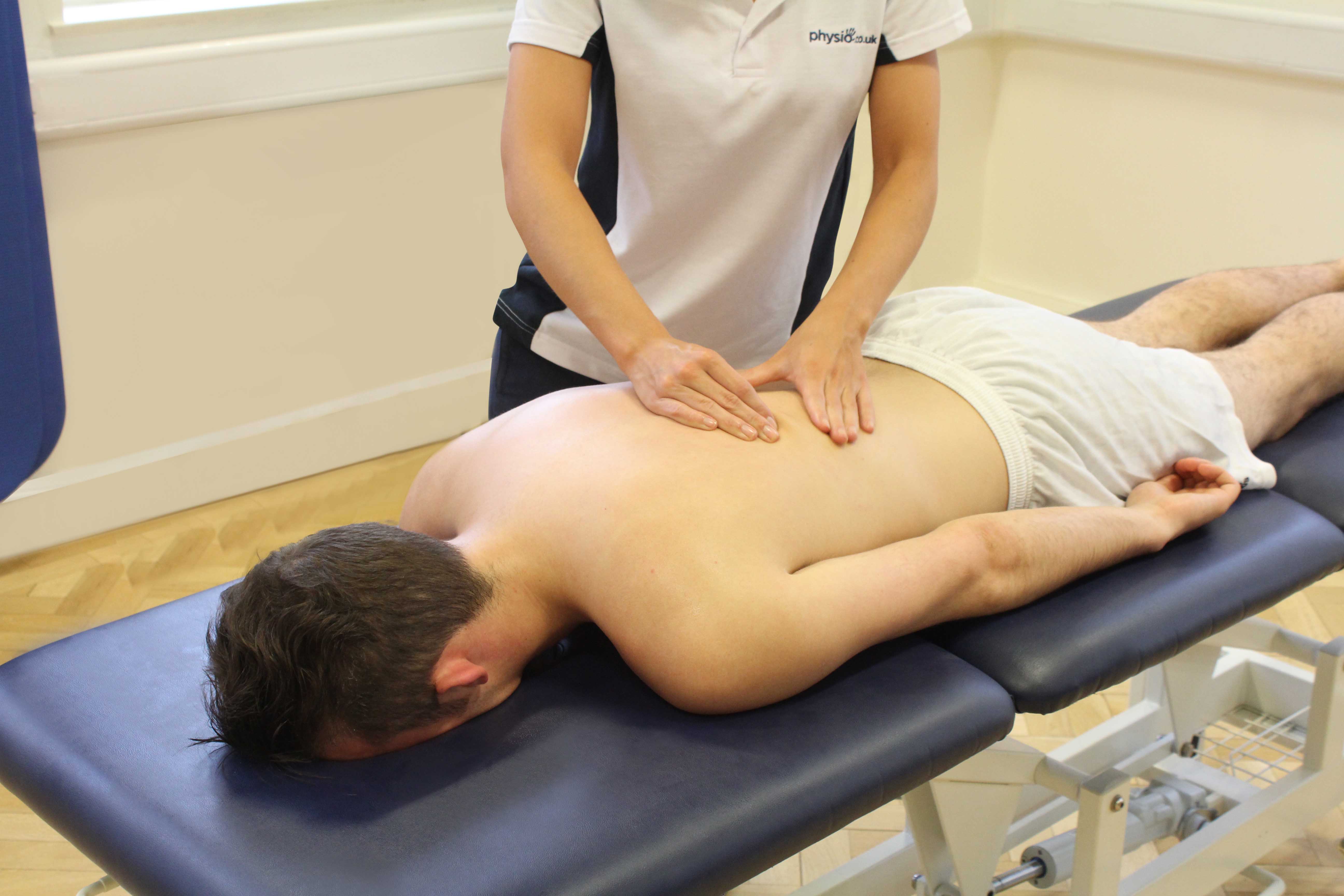 Soft tissue massage of the lower back muscles and connective tissue by specialist therapist