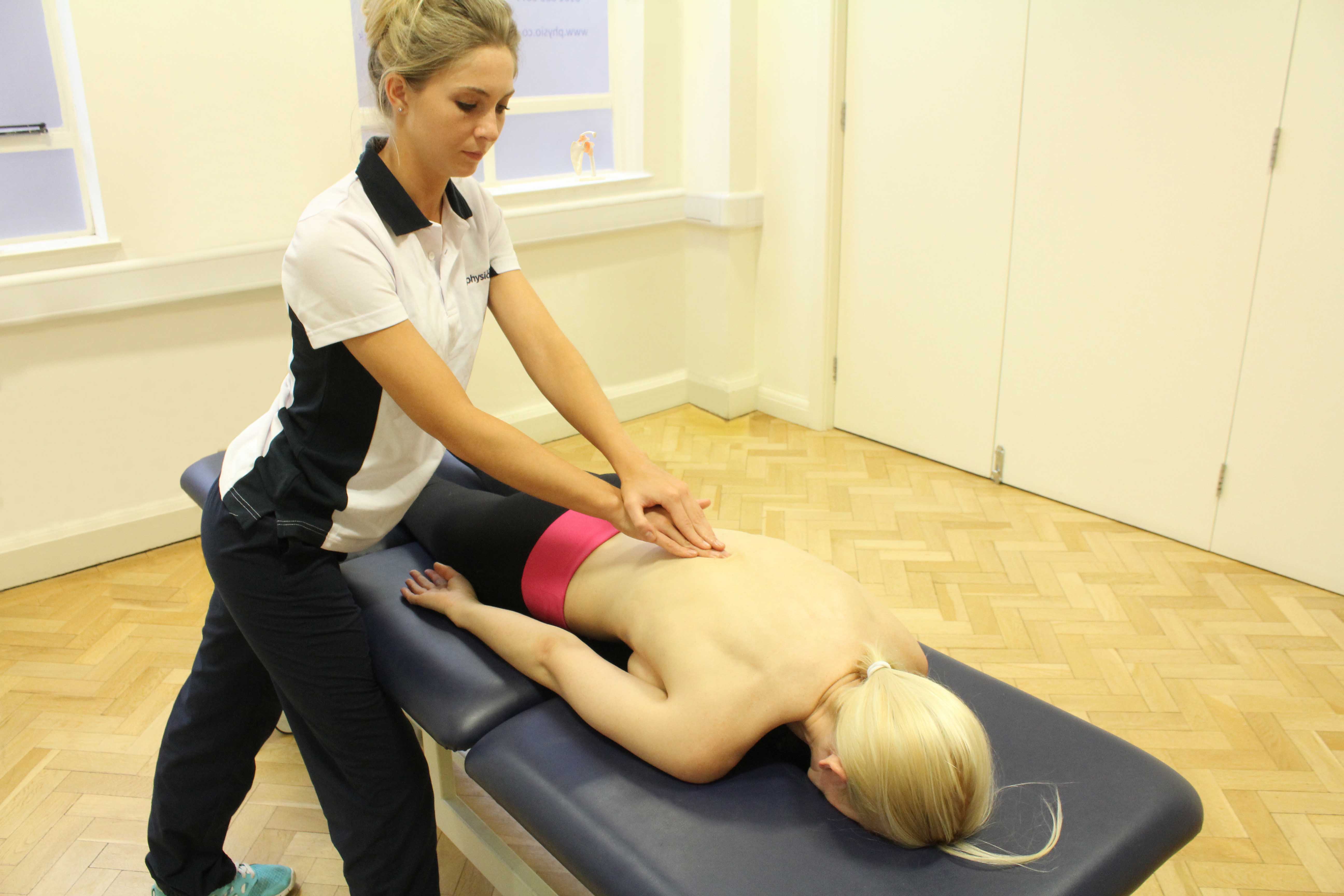 Soft tissue massage of the lower back muscles and connective tissue by specialist therapist