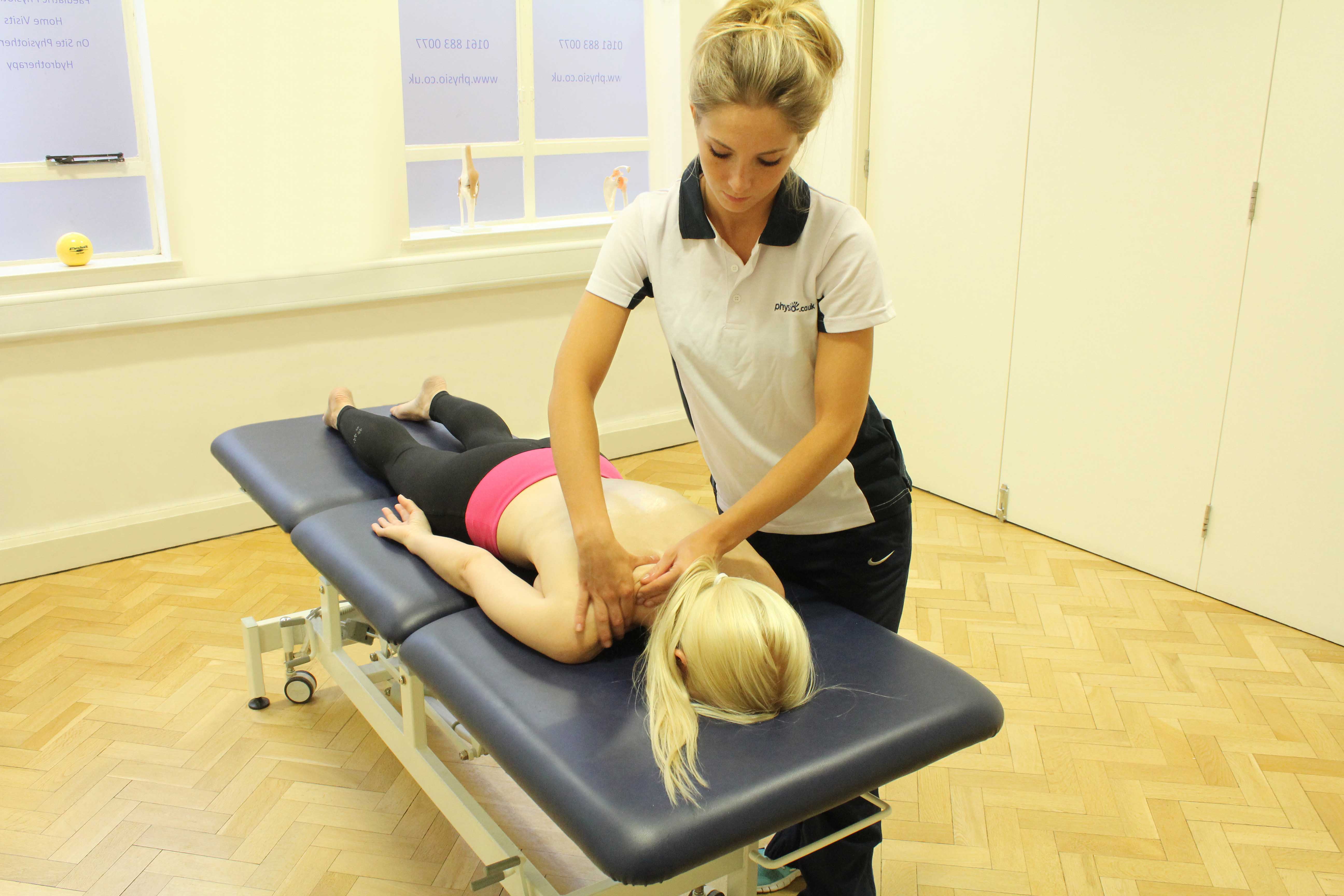 Soft tissue massage of the trapezius muscle in the shoulder Soft tissue massage of the trapezius muscle in the shoulder