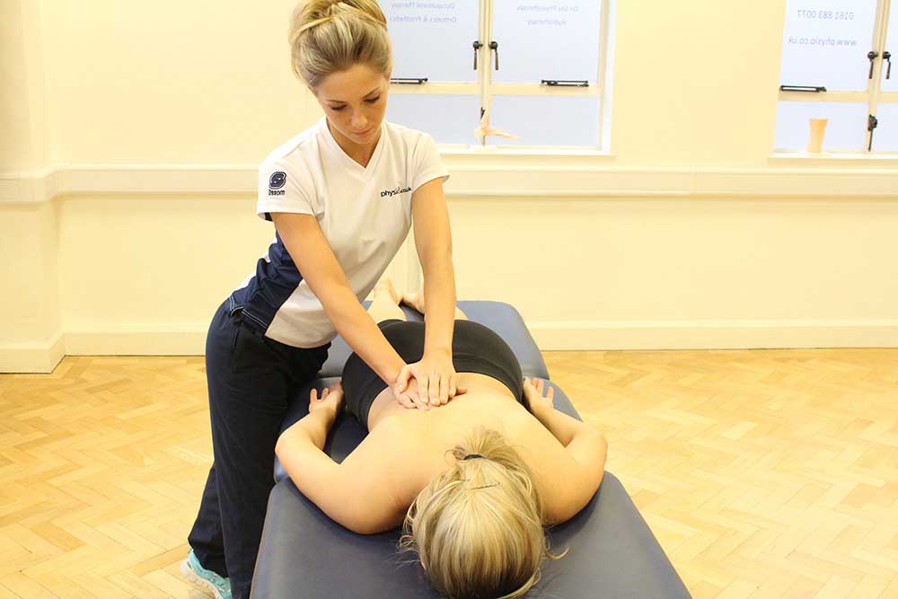 Therapeutic massage focusing on laissimus and rhomboid muscles